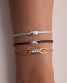 Moonlight and Iconix lab-grown diamond bracelets stacked on silk cords